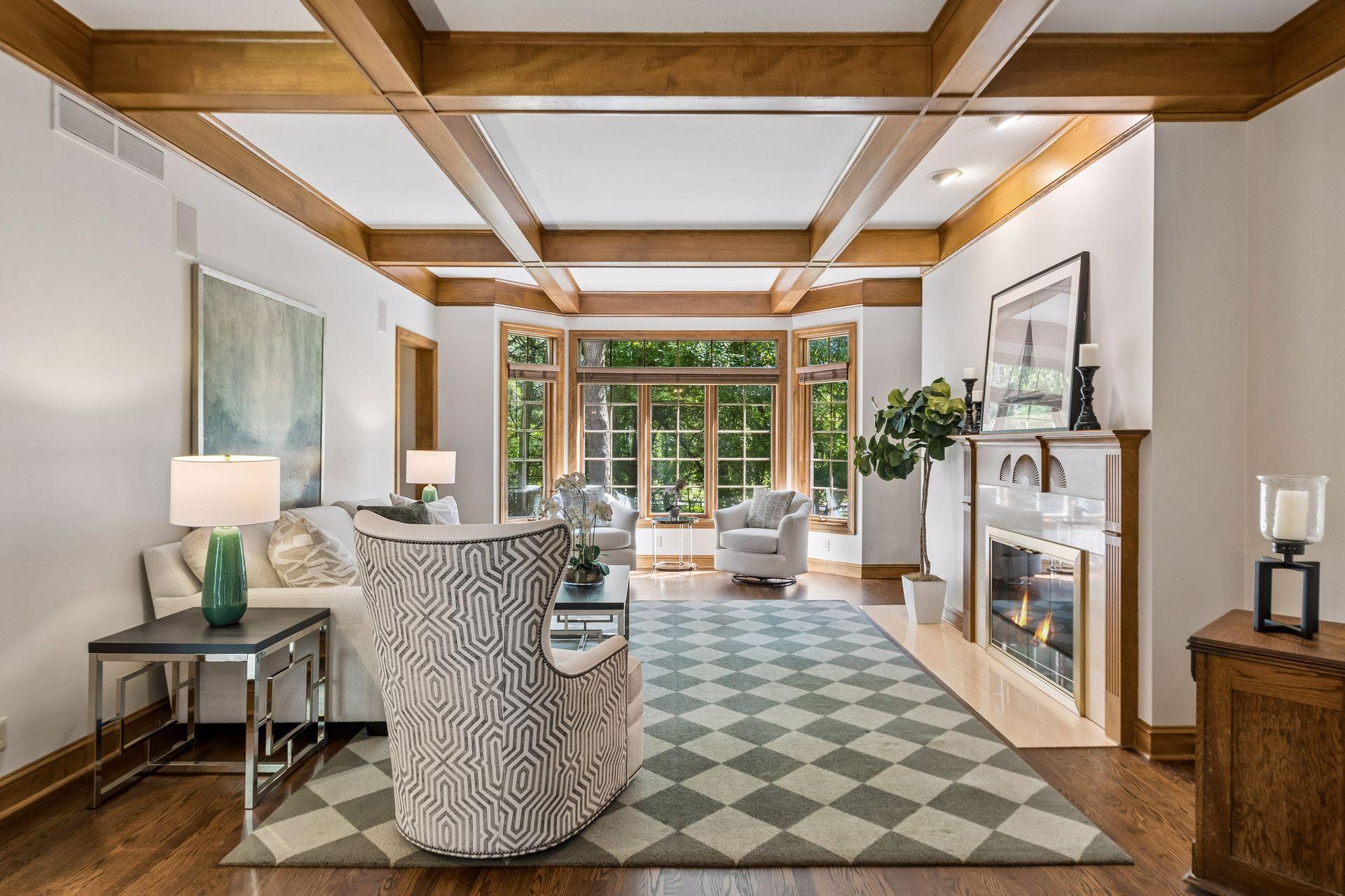 The living room features a wood-burning fireplace and clear views of the private backyard.
