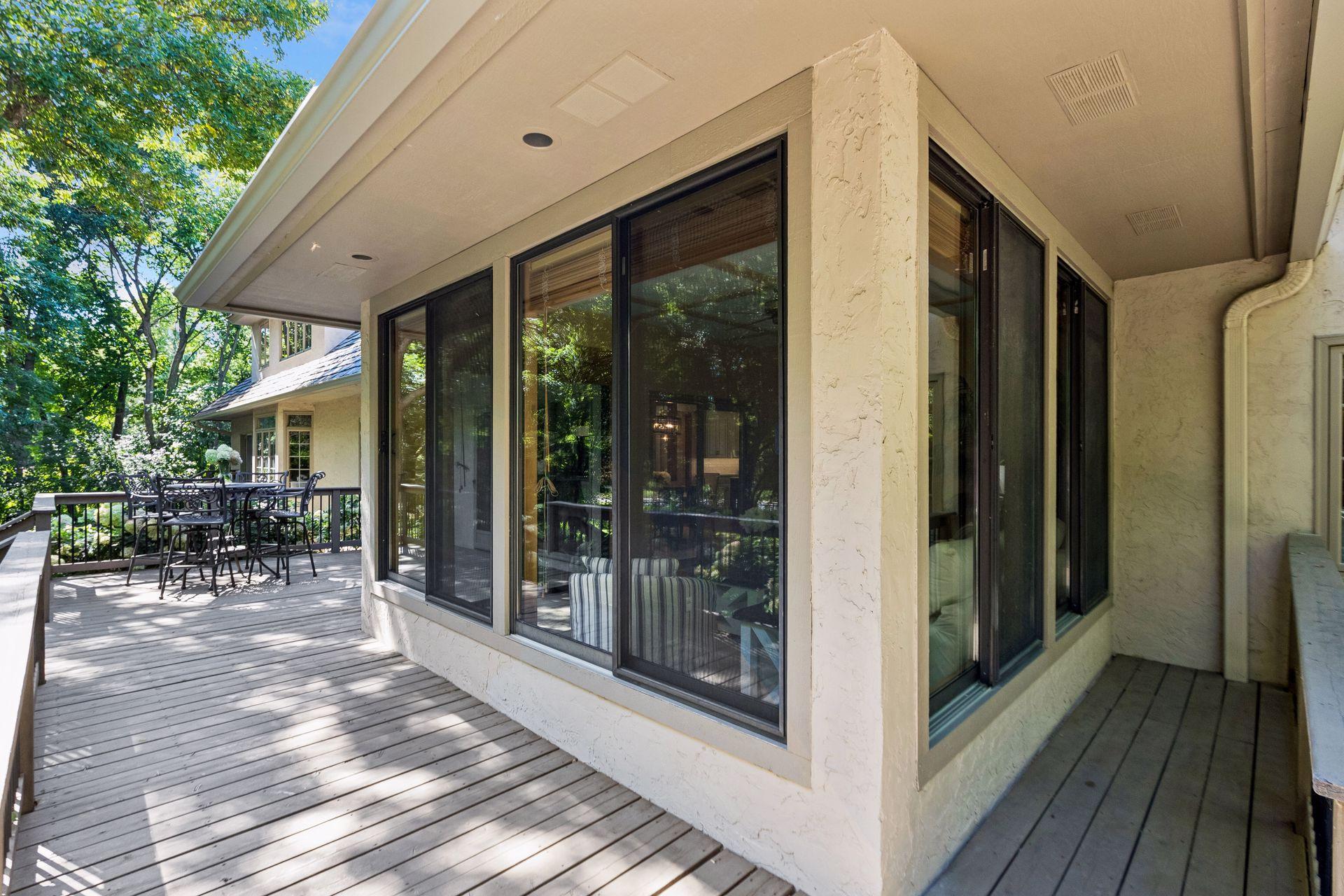 A 3-season porch surrounded by an expansive deck creates seamless indoor-outdoor living.