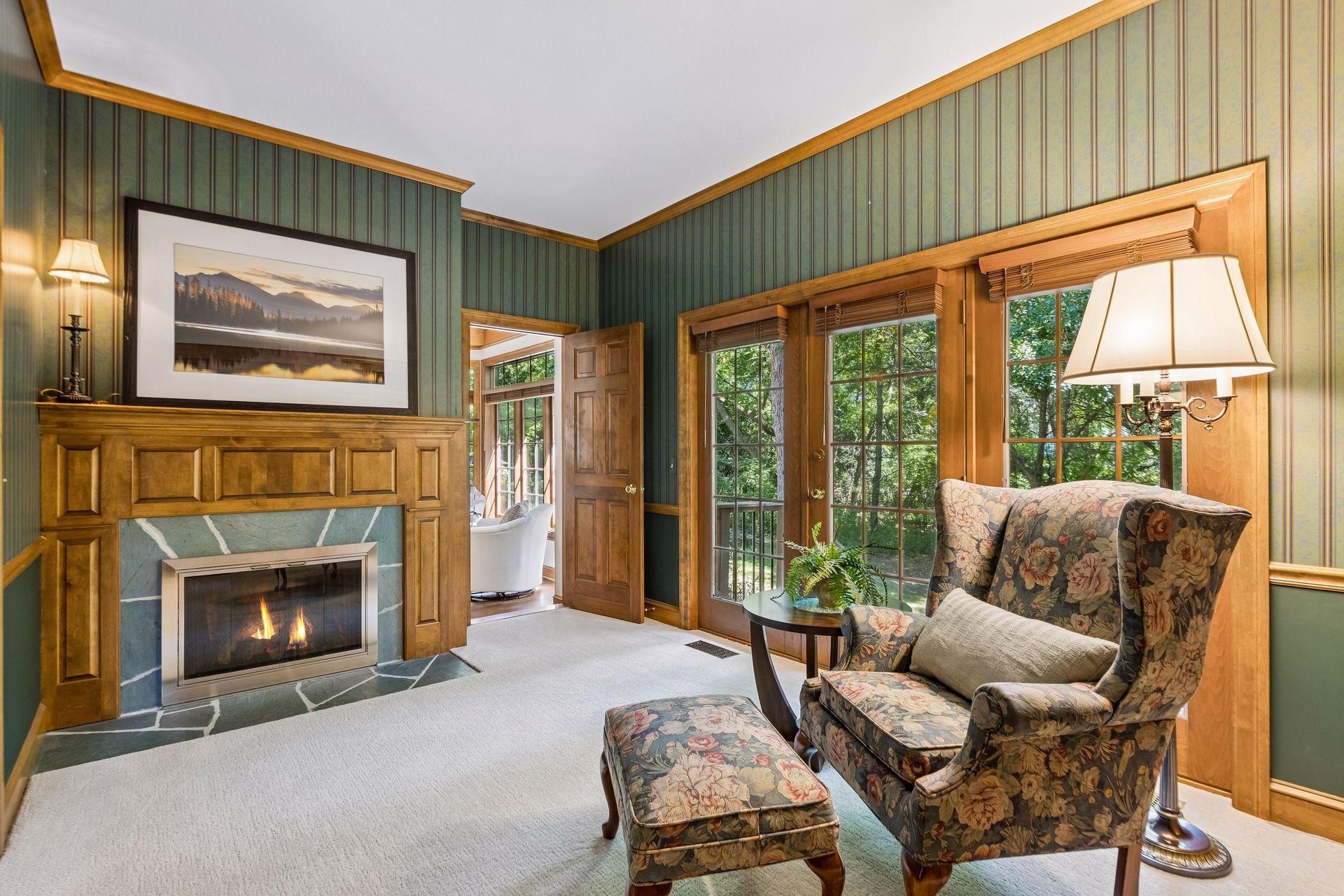 This attached office/sitting room offers direct access to the backyard and features a warm wood-burning fireplace.