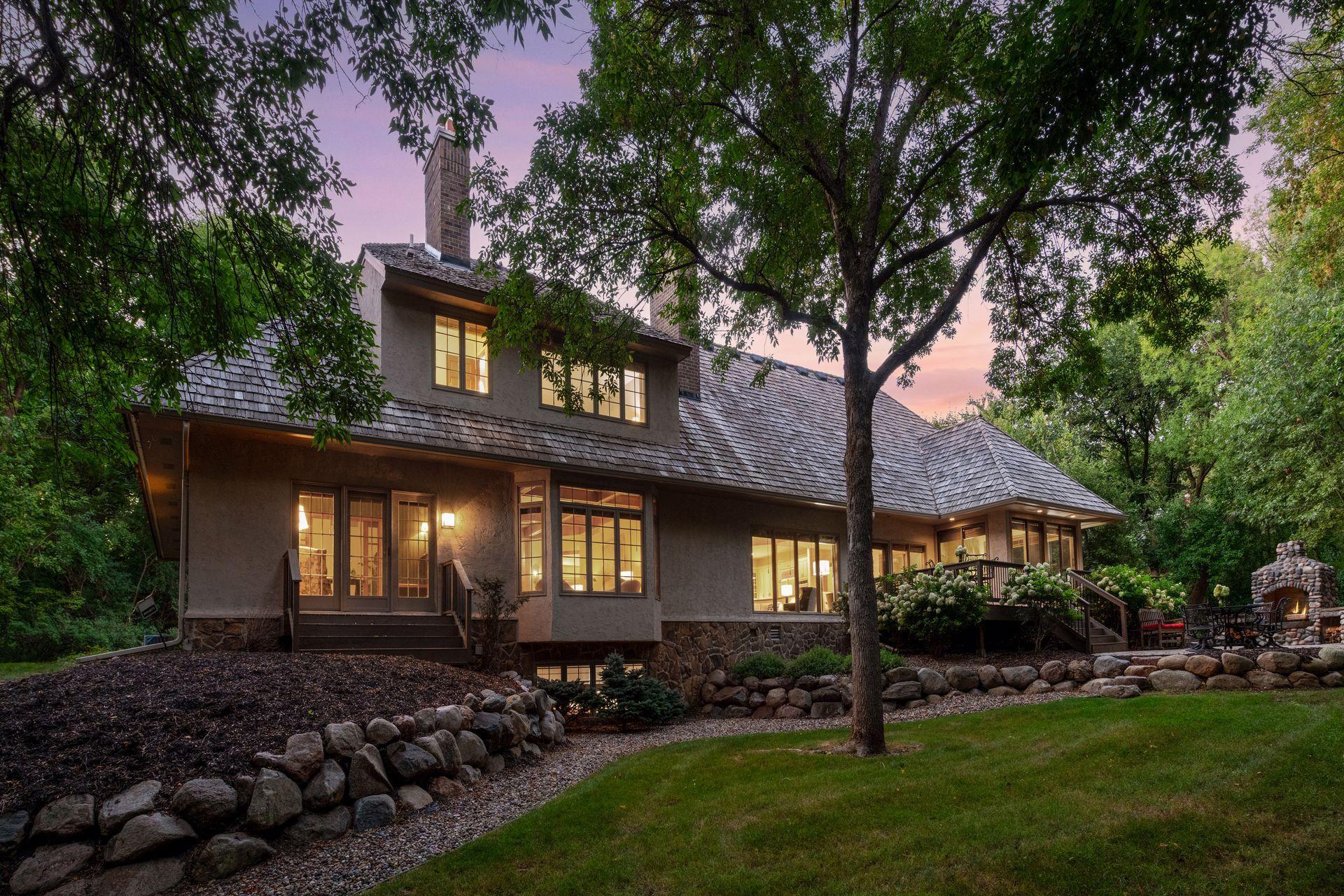 Back of home featuring expansive windows overlooking the private backyard.