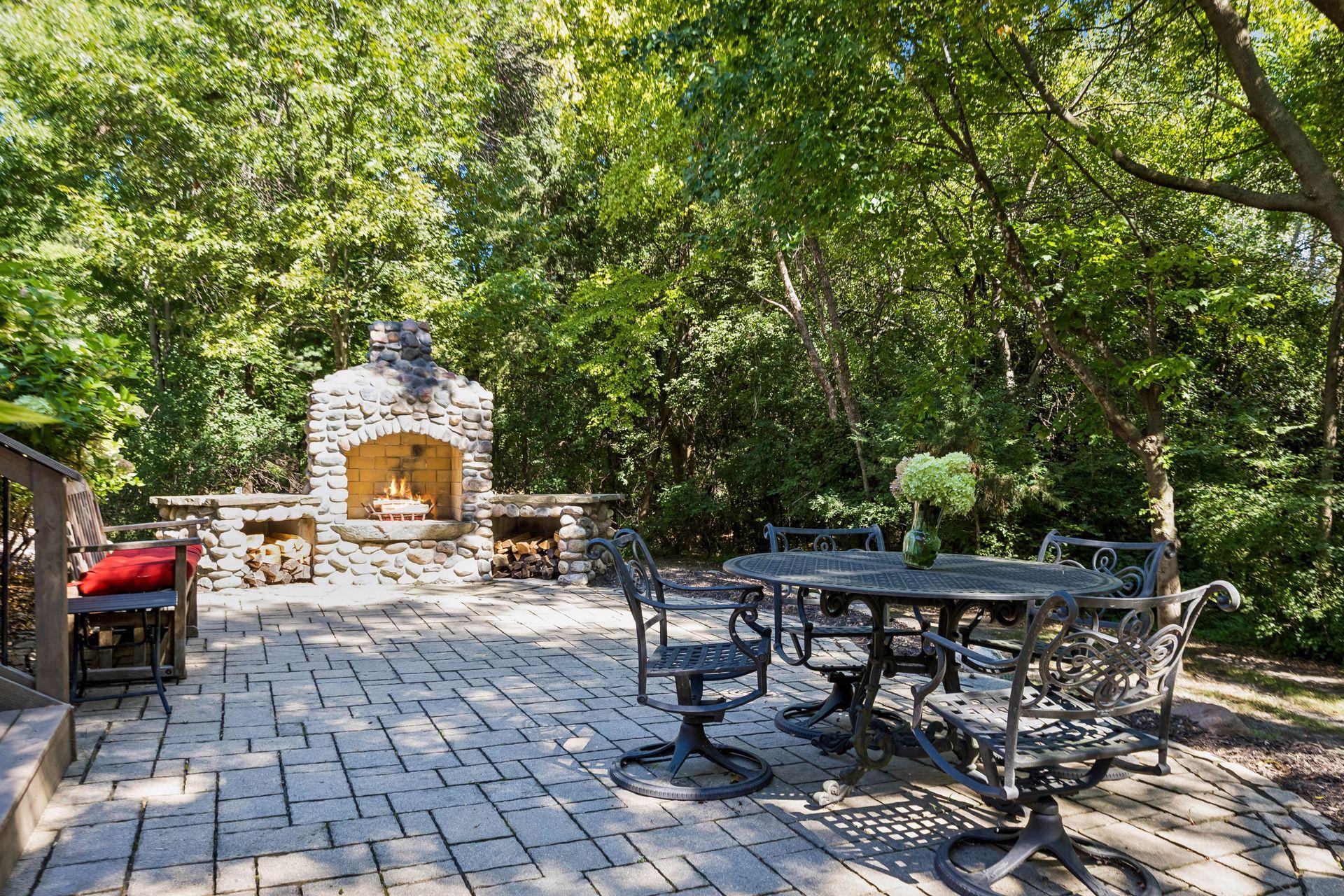 Charming wood-burning fireplace paired with a large patio, perfect for gatherings and relaxation.