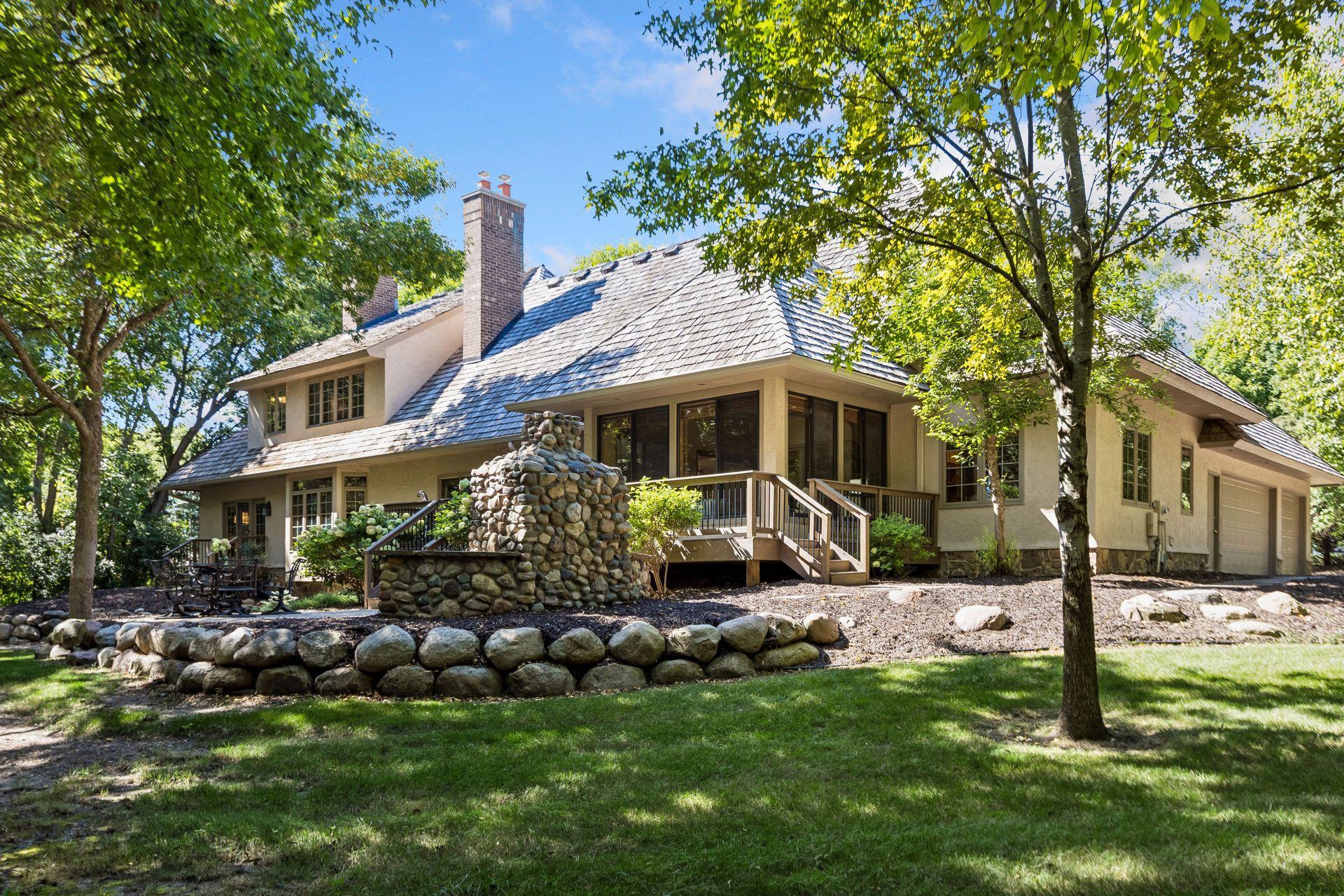 Large backyard enhanced with new trees and thoughtfully designed hardscapes for a refined outdoor retreat.