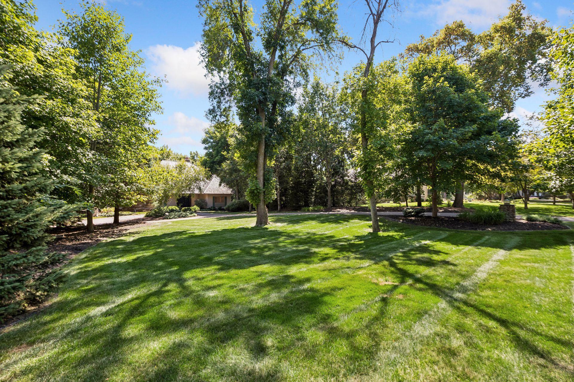 Large front yard with abundant green space and a newer irrigation system covering the entire property.