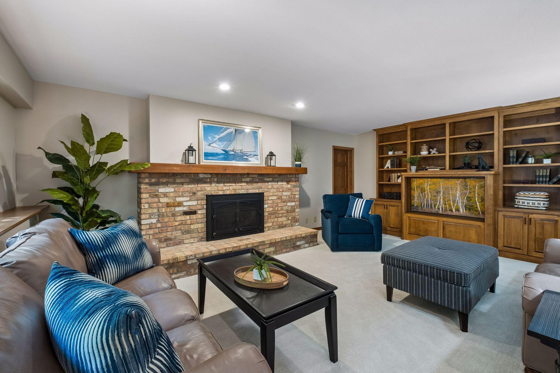 Spacious lower-level family room with custom built-ins and a gas fireplace adding comfort and charm.