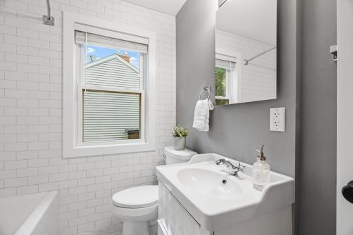 Main floor full bath with the coolest full tile wall. .