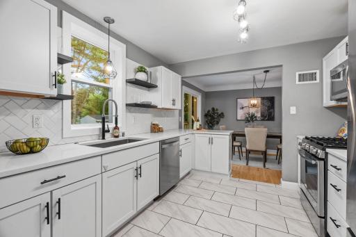Gas range, large sink, fantastic backsplash, and updated lighting round out this great space.