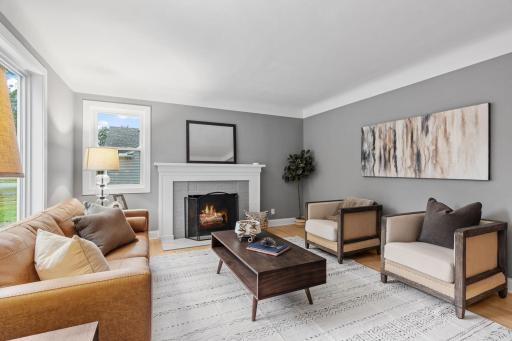 Enter the home into the living room w/ coved ceiling and fireplace.