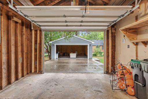 AMAZING! Pass through attached single car garage leads to a detached two car garage!