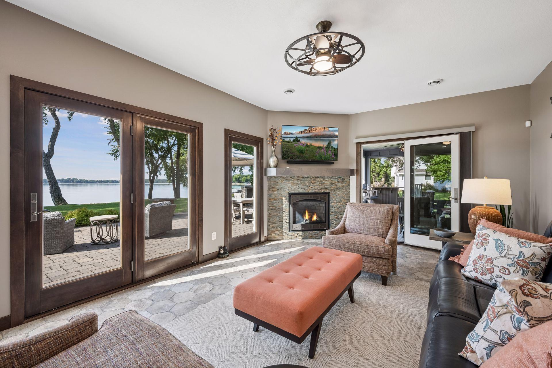 Sun-Drenched Sunroom with Cozy Fireplace & Serene Lake Views