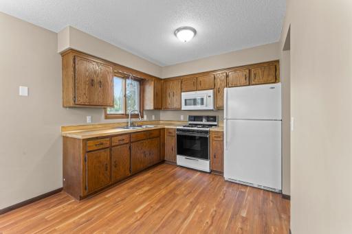 Newer microwave over the gas range.