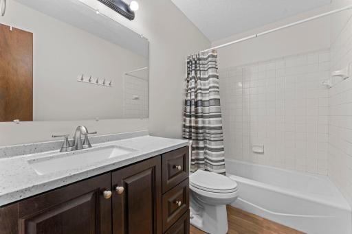 Newer vanity and stool in this bright and cheery full bathroom