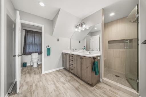 Notice the elegant styling walk-in shower and private stool area.