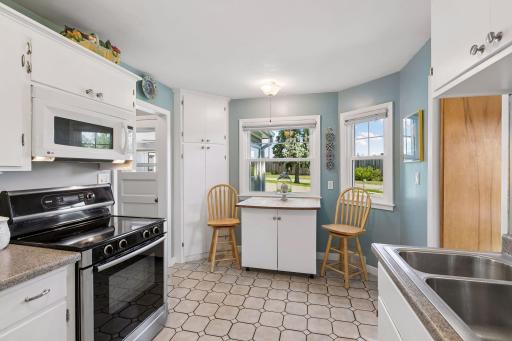 There's plenty of room for a dining table in the bay window area. The door to the far left rear leads to the sun porch and driveway