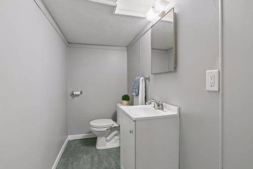 A shower could be added to the lower level half bath beyond the commode (there's an unfinished area behnd the wall)