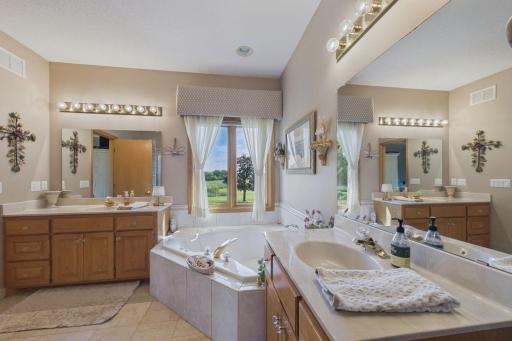 Primary bath with two vanities and a relaxing tub for relaxing.