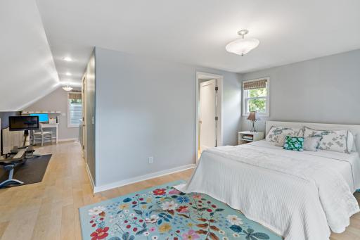 Spacious upper-level primary suite with newer maple hardwood floors and a generous bonus area - room for a home office, workout space, reading nook, or lounge.