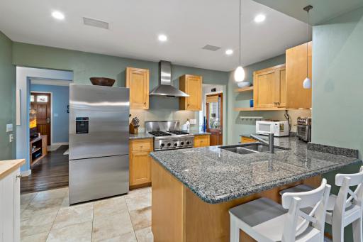 Breakfast bar, gas range, newer stainless refrigerator and dishwasher, recessed lighting - everything you need.