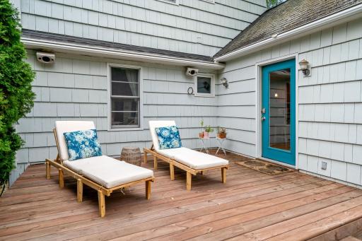 Newer back deck (2023) with mature evergreen creating natural privacy - your own quiet backyard refuge.