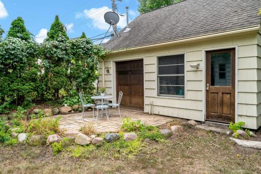 Surrounded by established garden beds, a detached, two-car heated garage is tucked at the back of the lot. The side garage door provides easy access to the second paver patio.