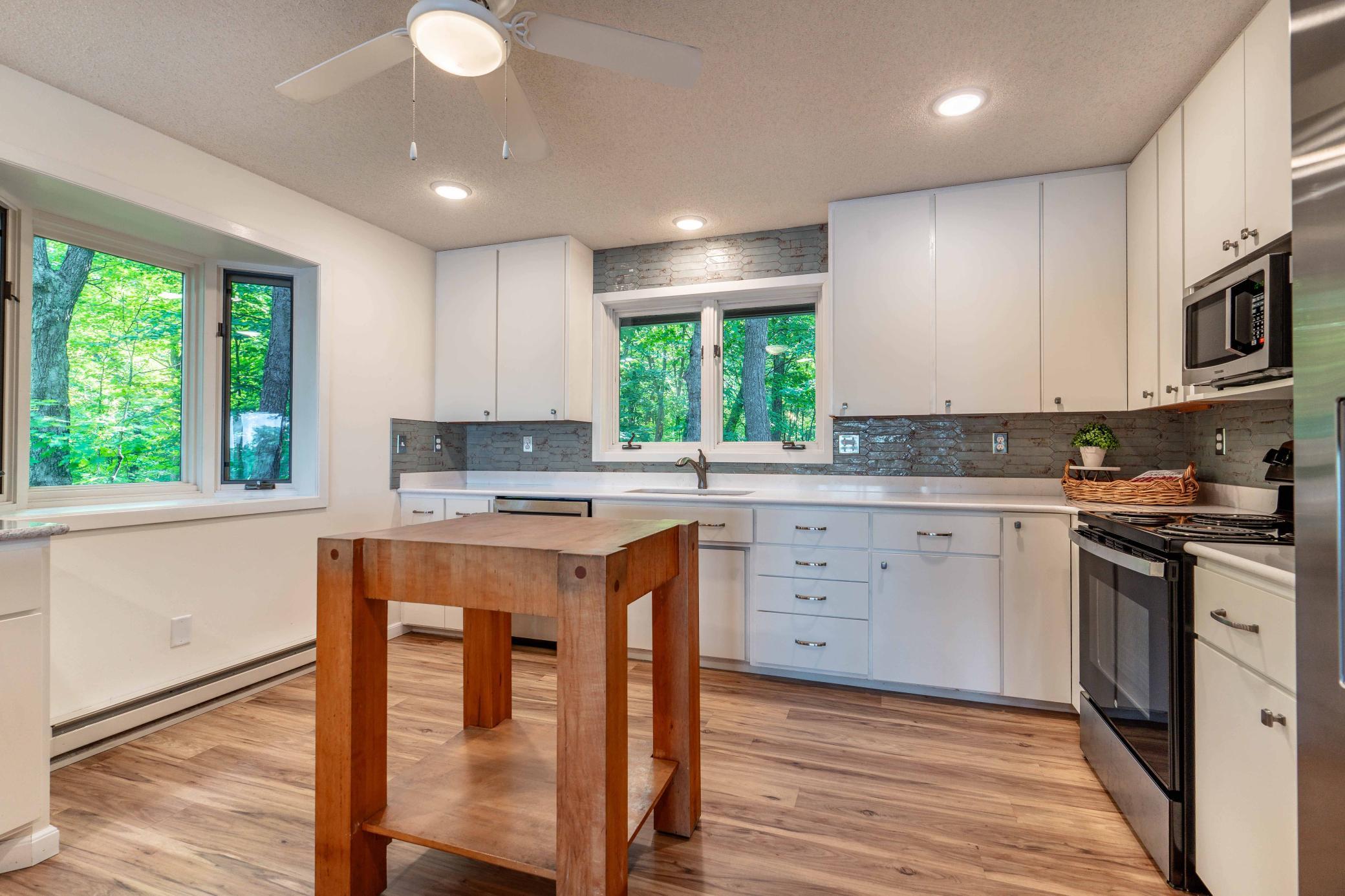 Fun butcher block island for your sous chef prep. Windows on every wall possible.