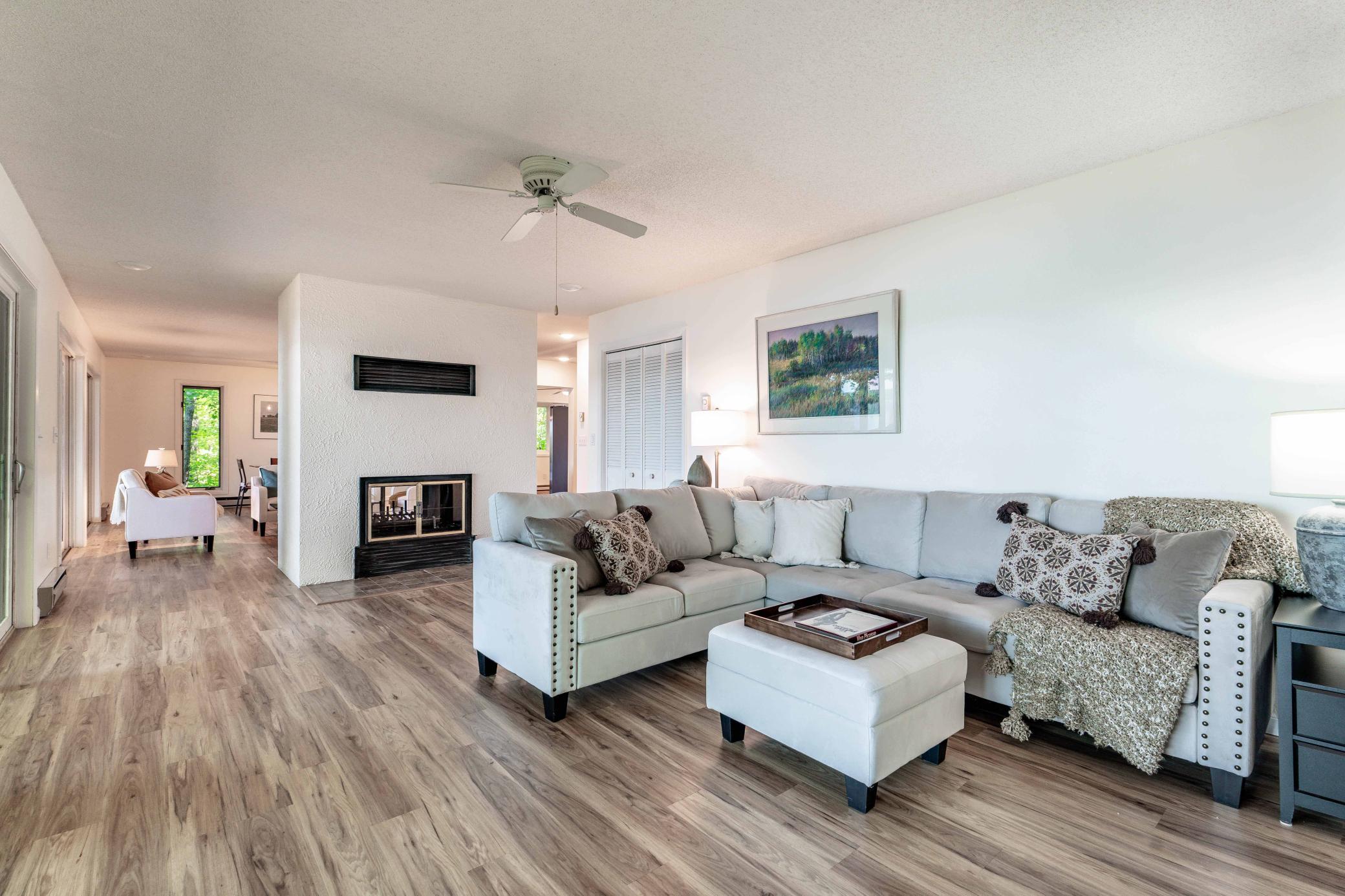 Extending to the alternate side of the fireplace lies yet another casual living room space.