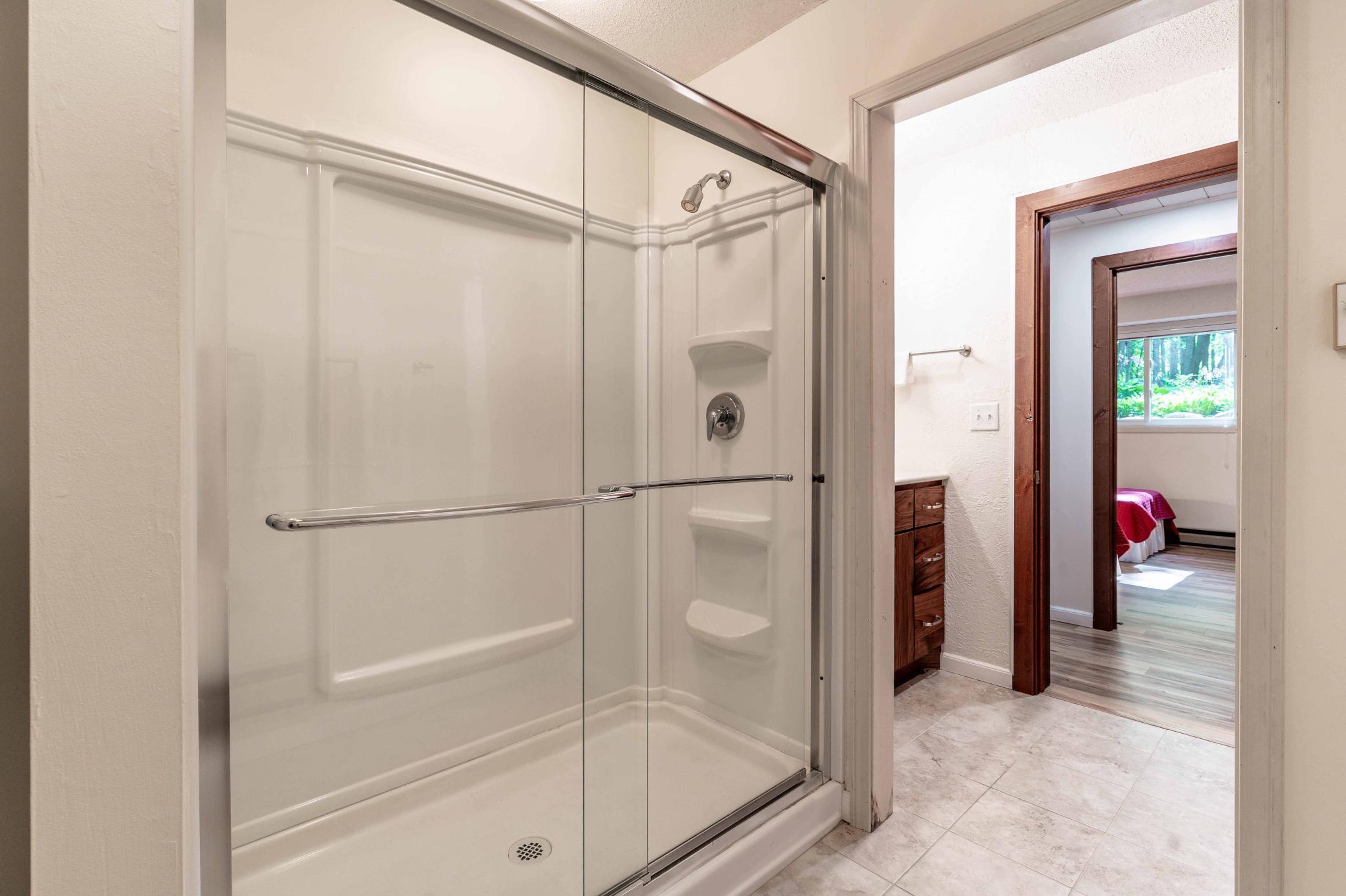 Updated shower enclosure with glass doors
