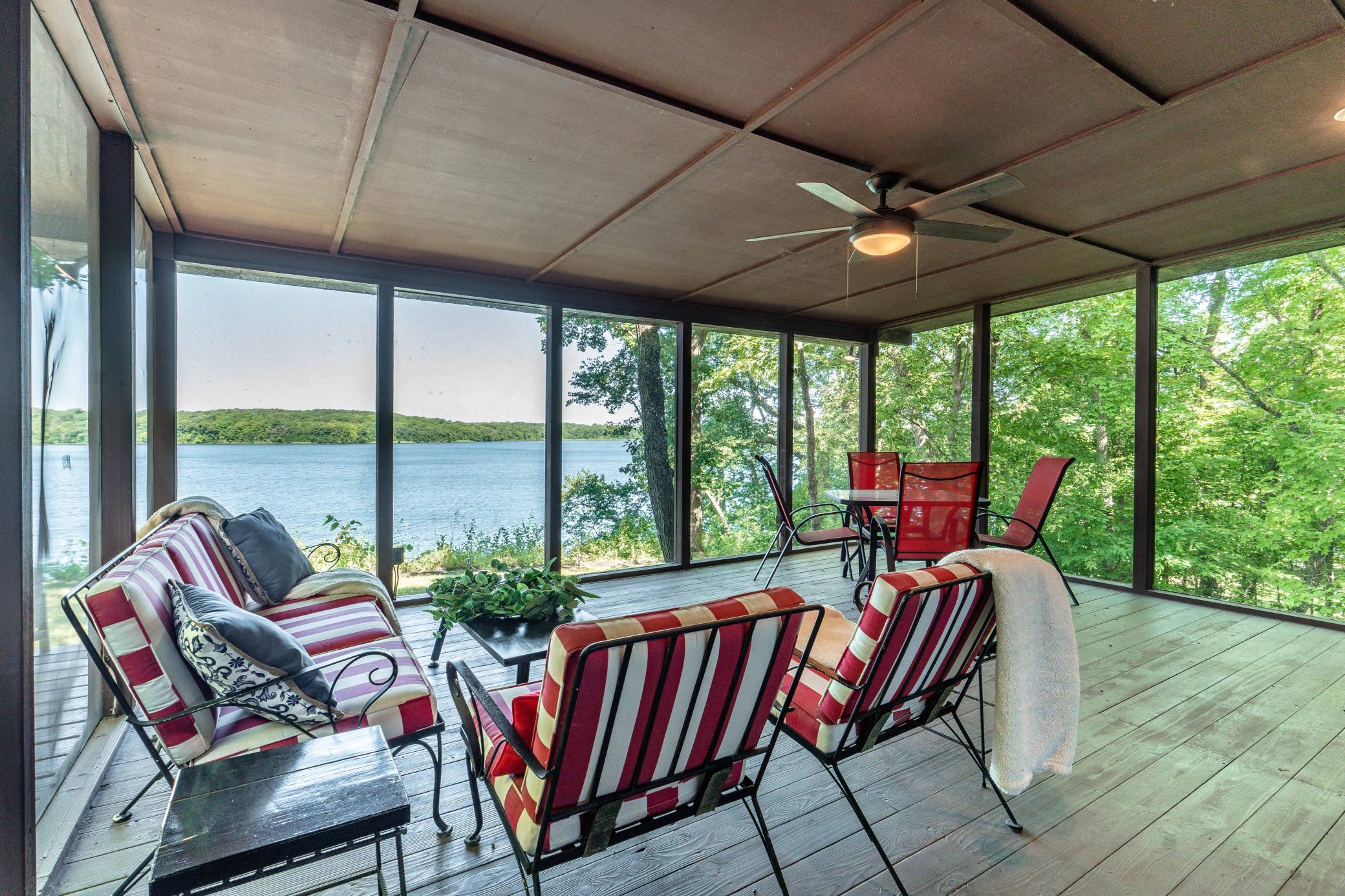 Lovely and large screen porch complete with ceiling fan