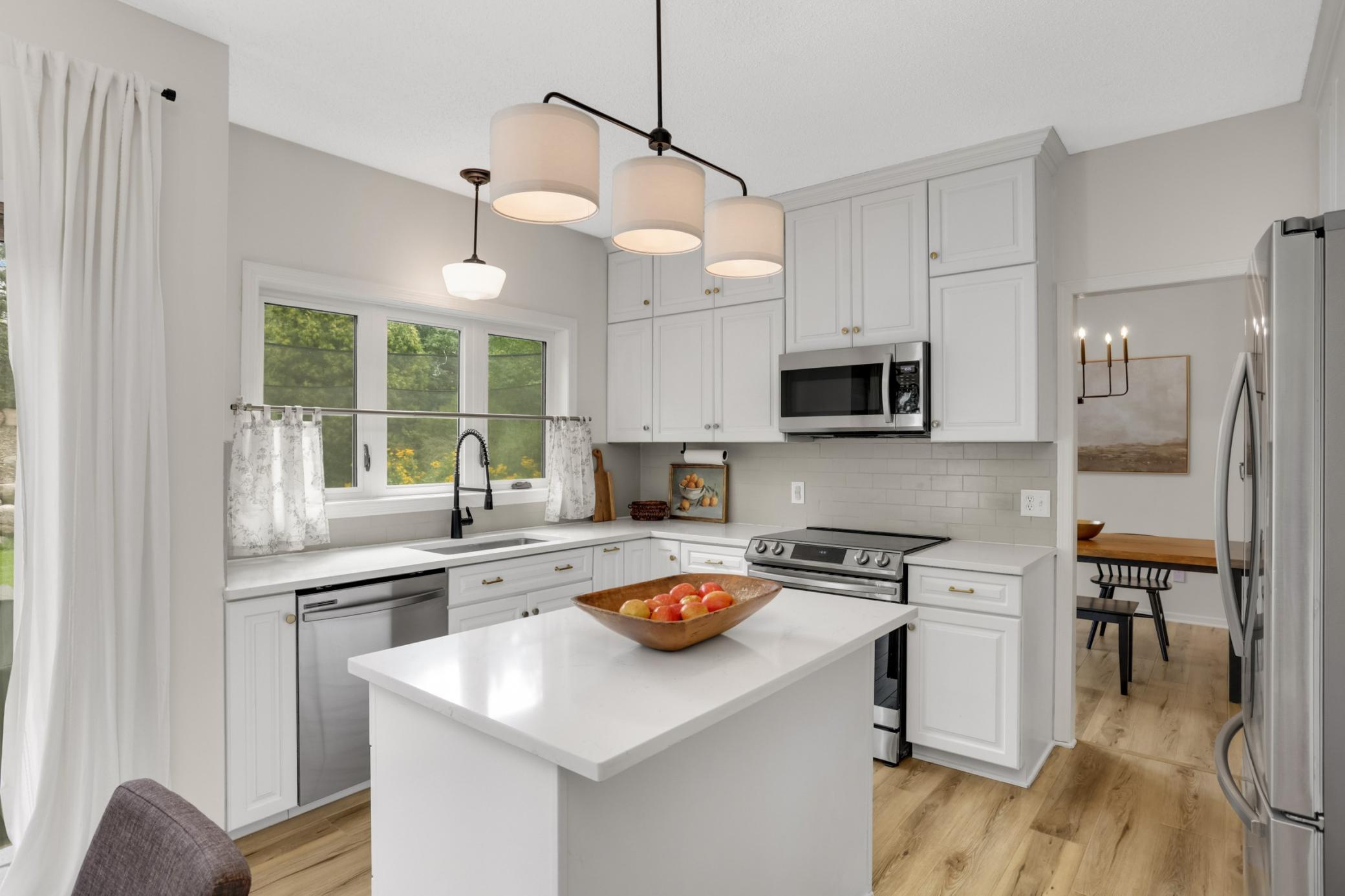 Just off the formal dining room is the kitchen. Tasteful fixtures, newer stainless steel appliances and windows overlooking the back yard.