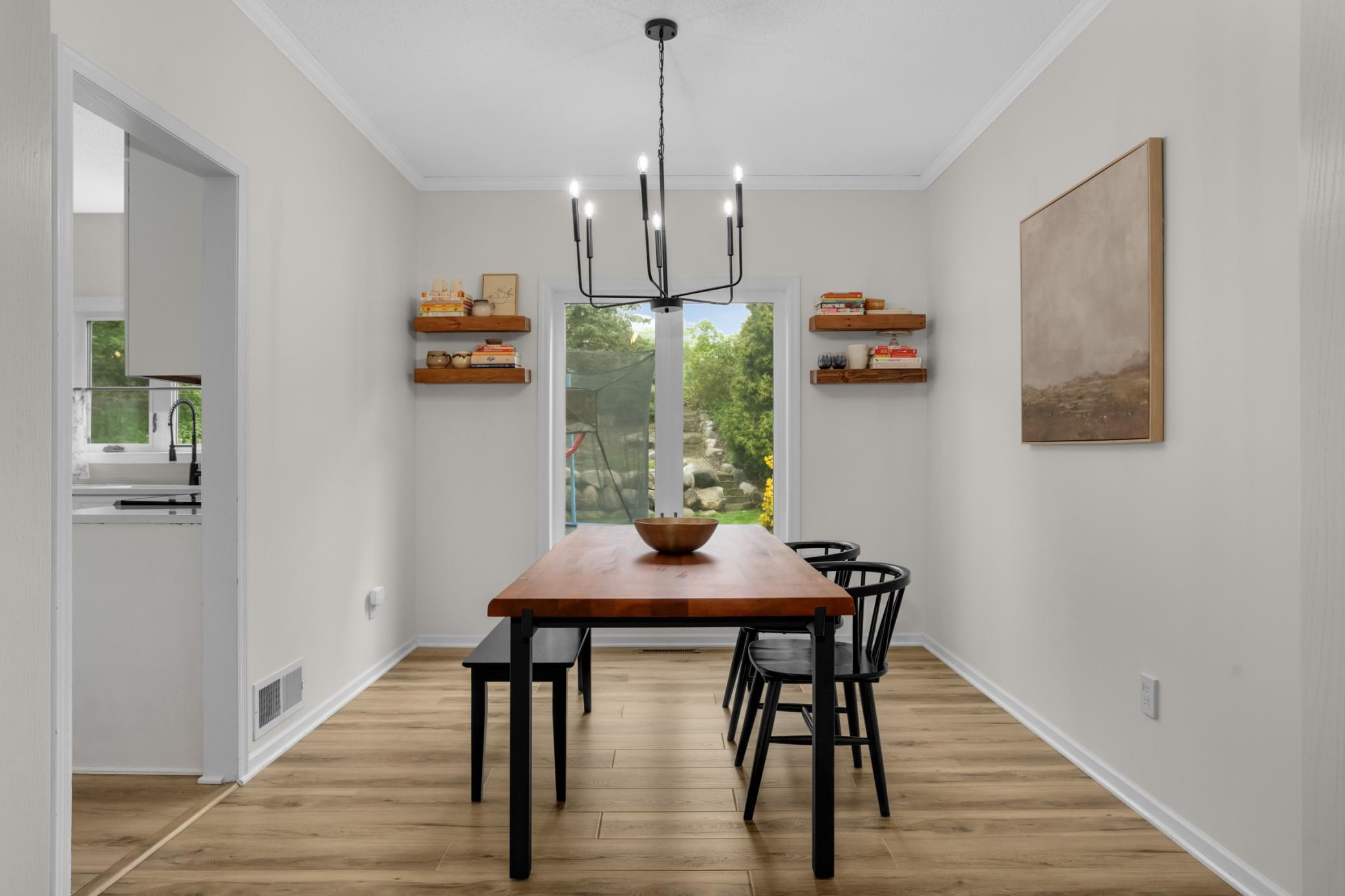 Formal dining room with huge window to the back yard, tall ceilings and updated lighting fixture.