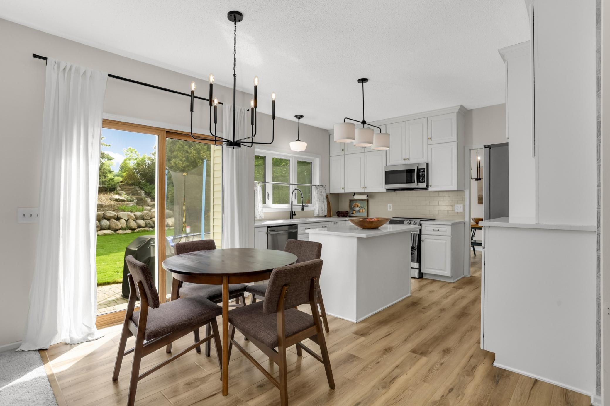 An informal dining space with sliding patio door to the backyard and paver patio. Great for grilling.
