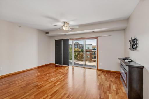Enjoy the spacious living area with beautiful hardwood floors, abundant natural light, and sliding glass doors leading to a private balcony.