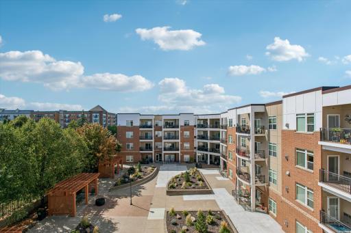 With mature trees, landscaped gardens, pergolas, and gathering areas, the courtyard feels more like an extension of home than a shared space.