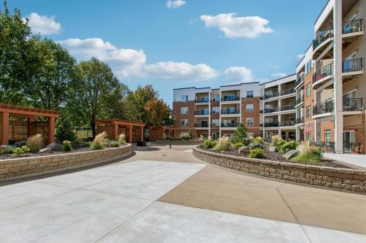 With mature trees, landscaped gardens, pergolas, and gathering areas, the courtyard feels more like an extension of home than a shared space