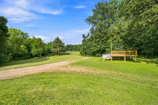 Expansive front yard with deck for easy pool access.