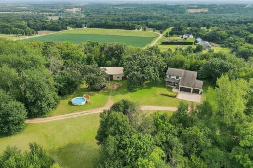 Welcome home to this serene private country estate, featuring a spacious home, versatile pole building, 12.5 acres and an above-ground pool (virtually enhanced to illustrate water).