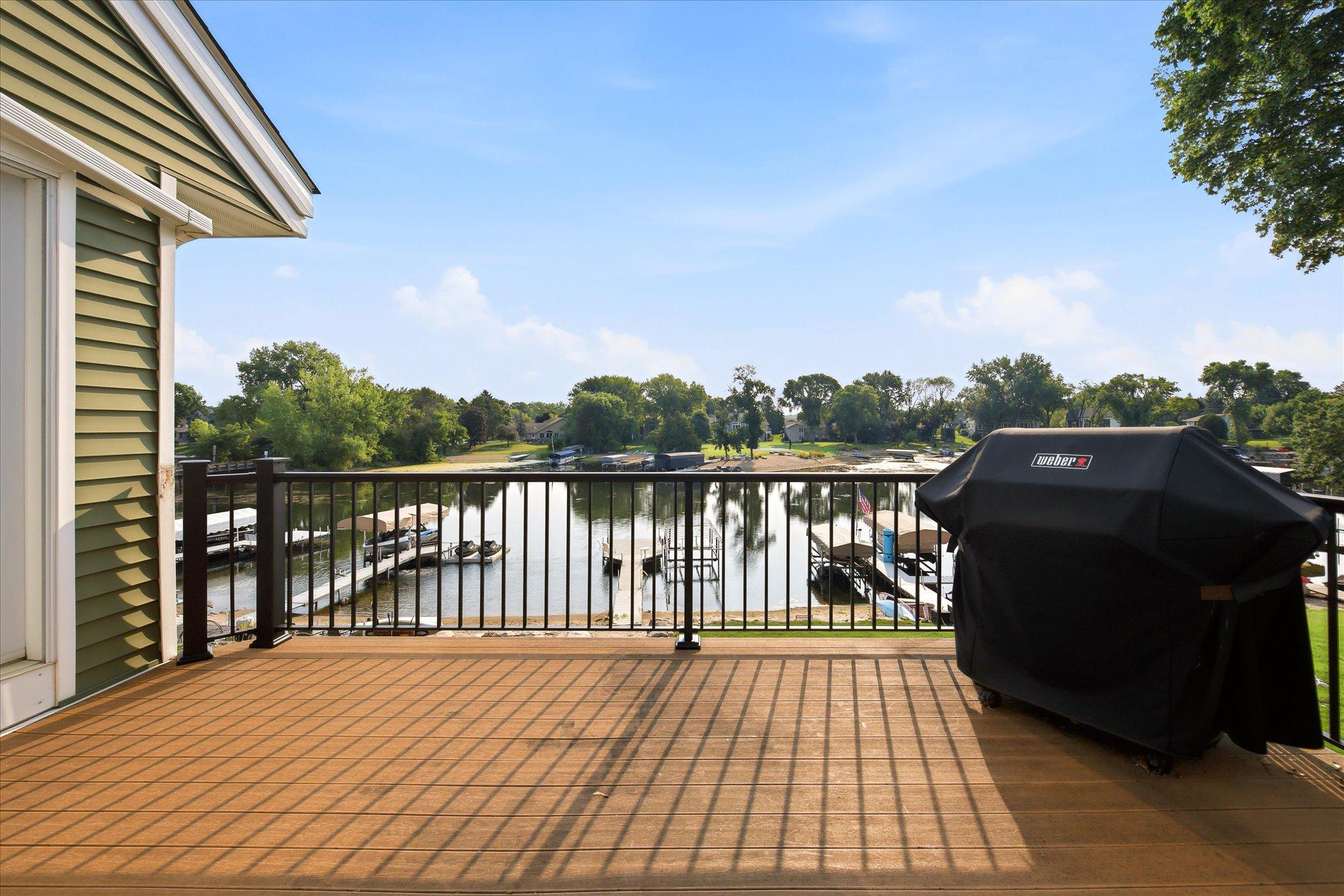 Newly installed deck railings frame the elevated deck overlooking Prior Lake.