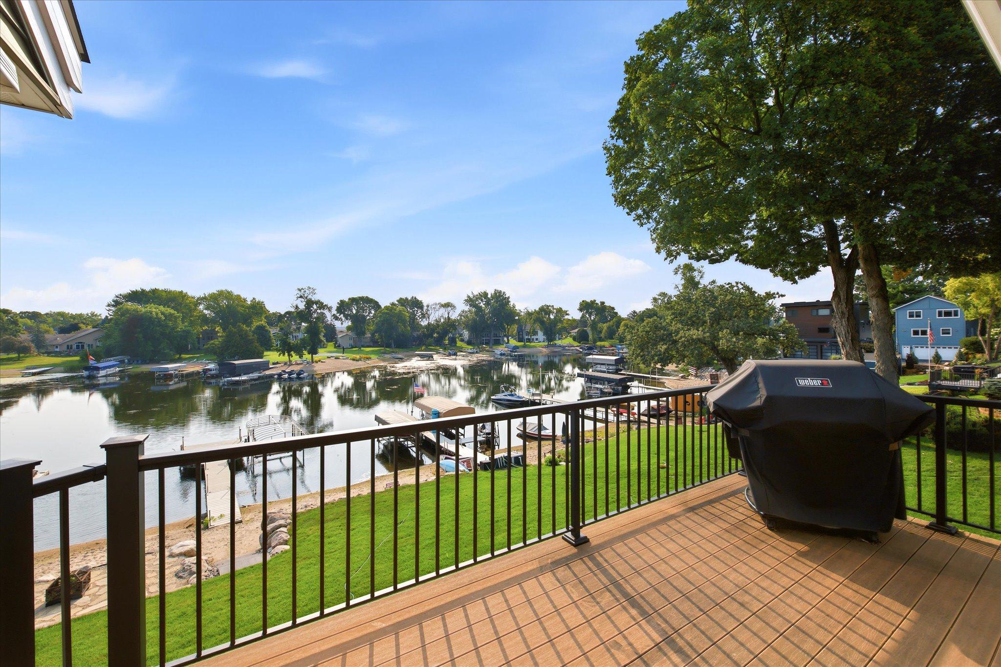 Elevated lakeside deck with new railings and expansive views of the water and shoreline.