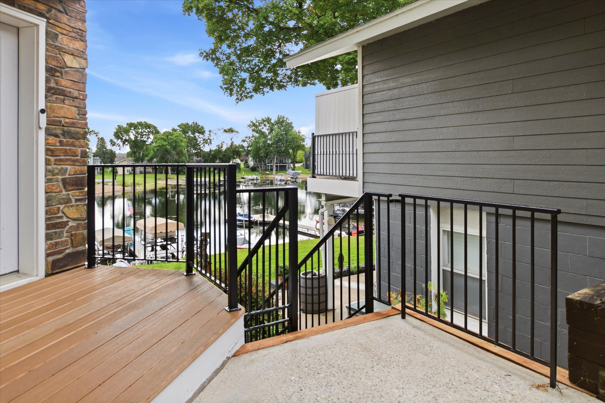 Newly installed black iron stair railings leading to the lake