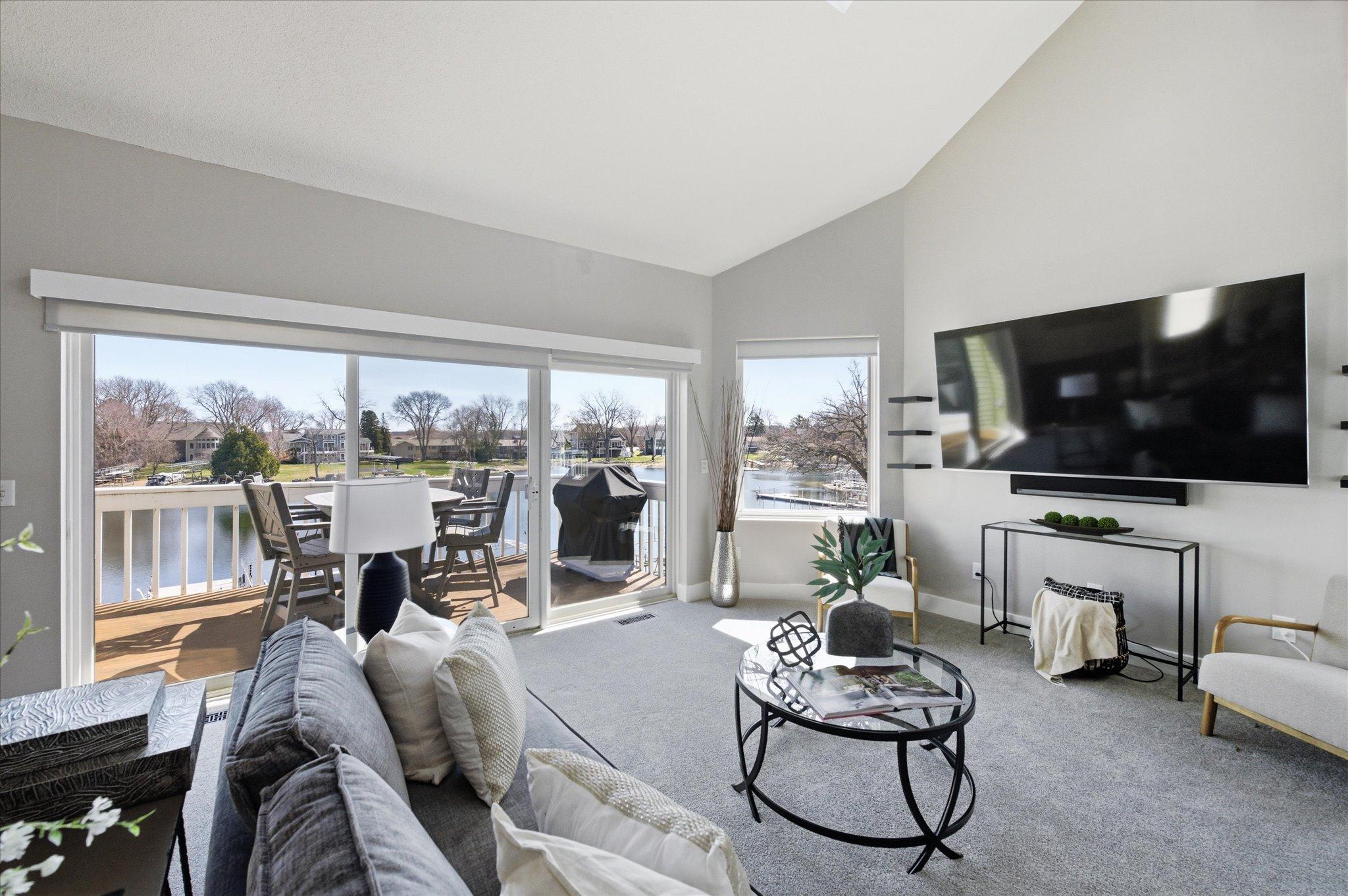 Living room overlooking the lake with direct access to the maintenance-free deck.