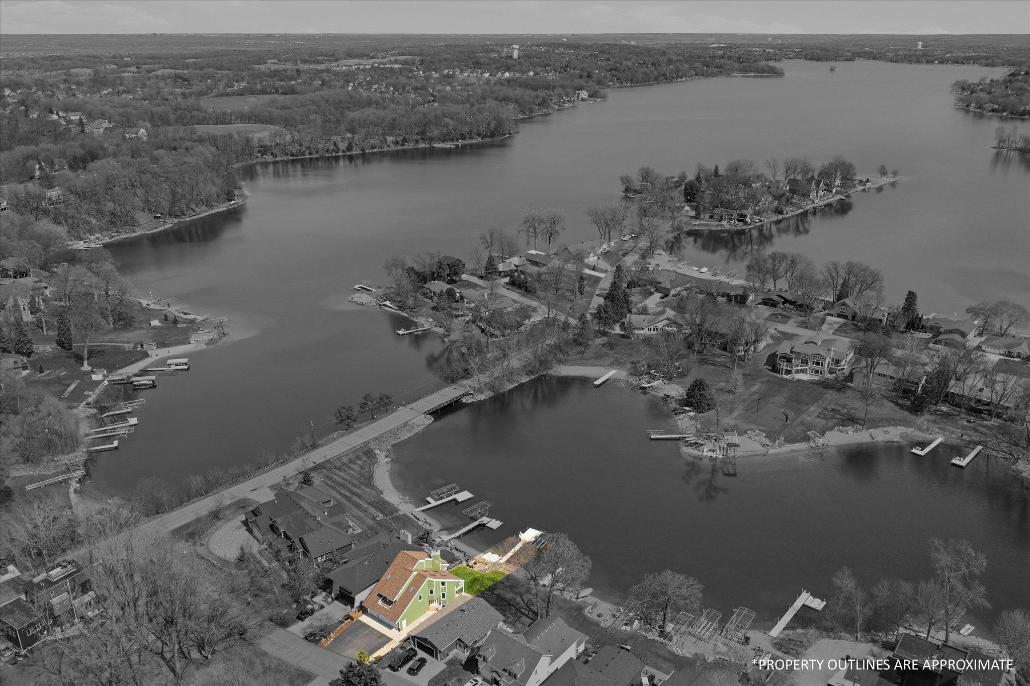 Aerial view highlighting the subject property and its premier lakefront location. Property lines are approximate.