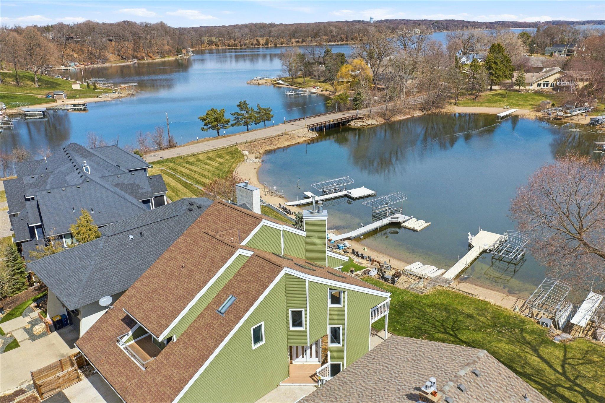 Aerial view showcasing the protected bay, nearby channel, and access to Lower Prior Lake.