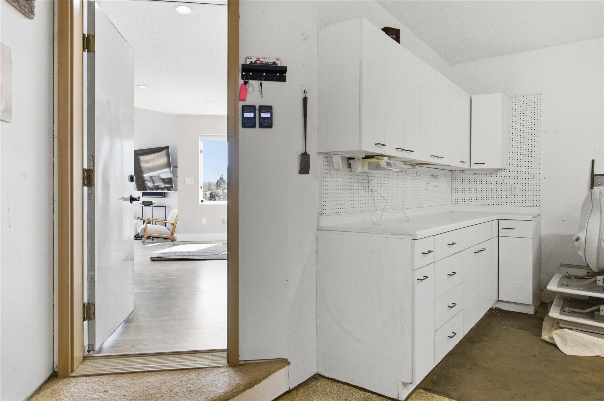 Garage workshop featuring built-in cabinetry and counterspace
