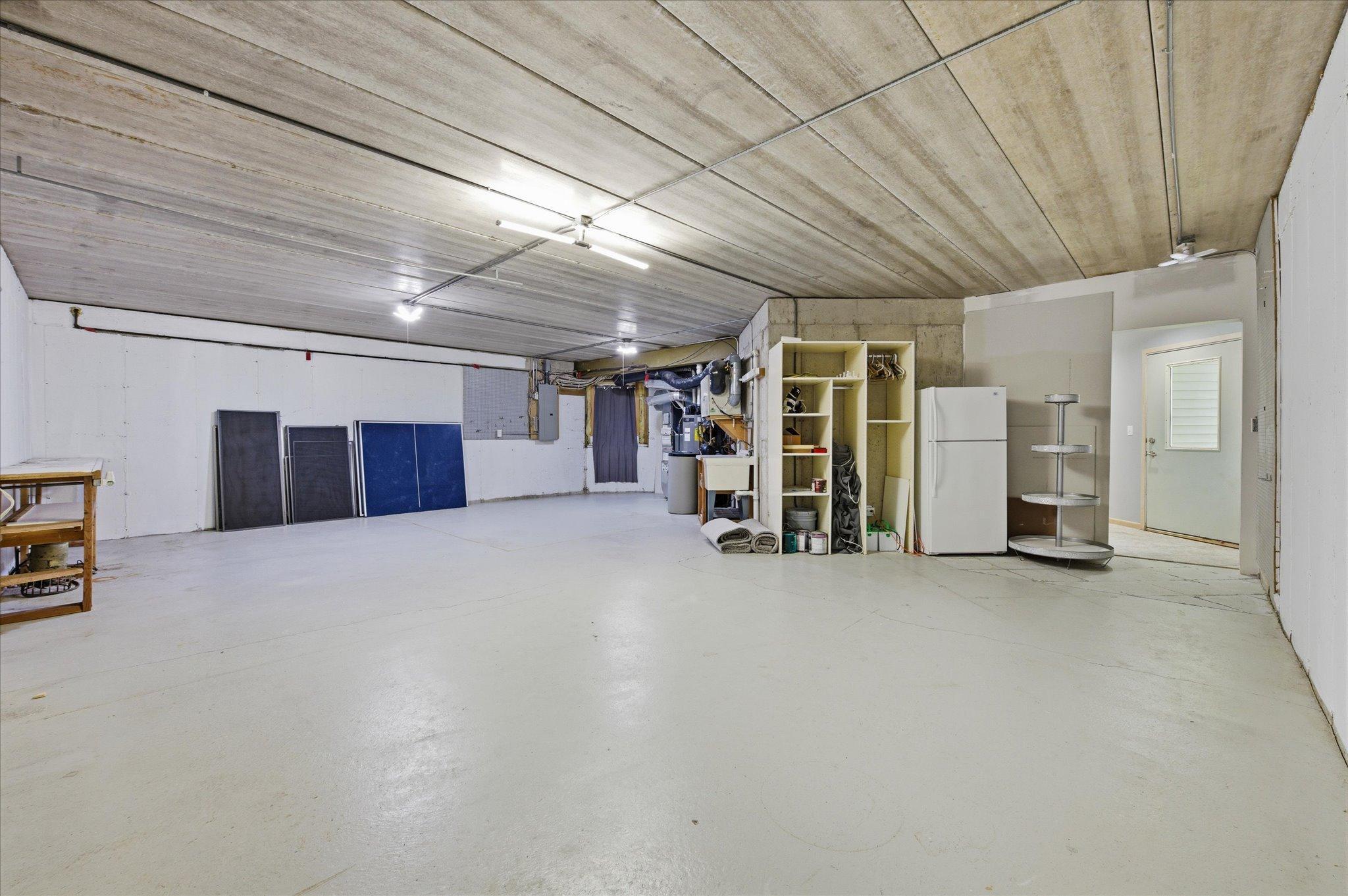 Spacious unfinished storage area offering abundant storage and workshop potential.