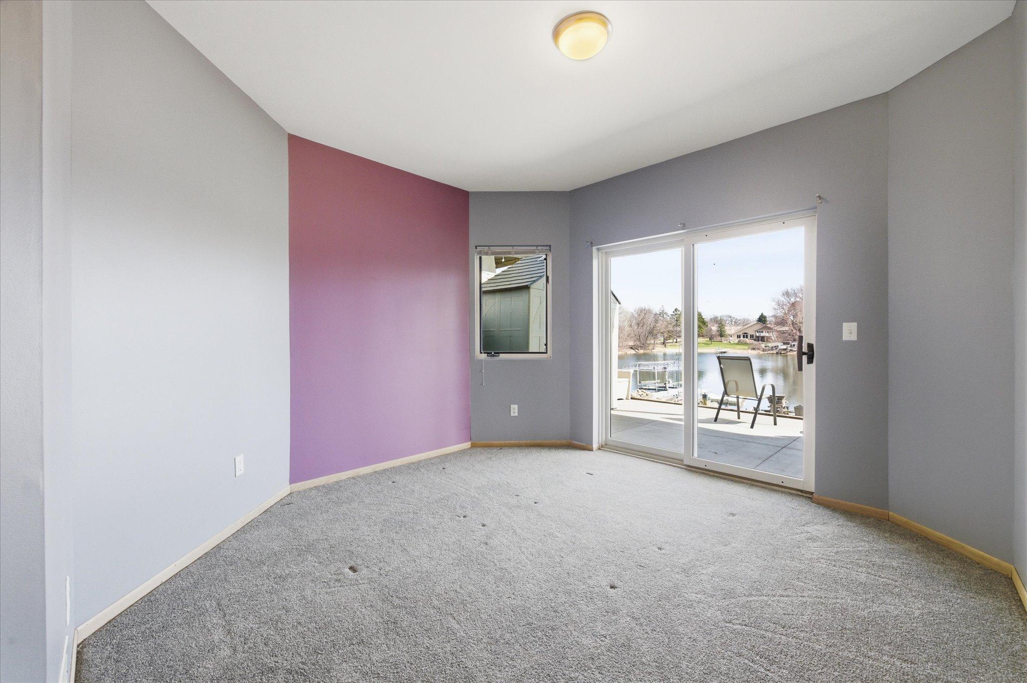 Additional bedroom with walkout patio access and lake views.