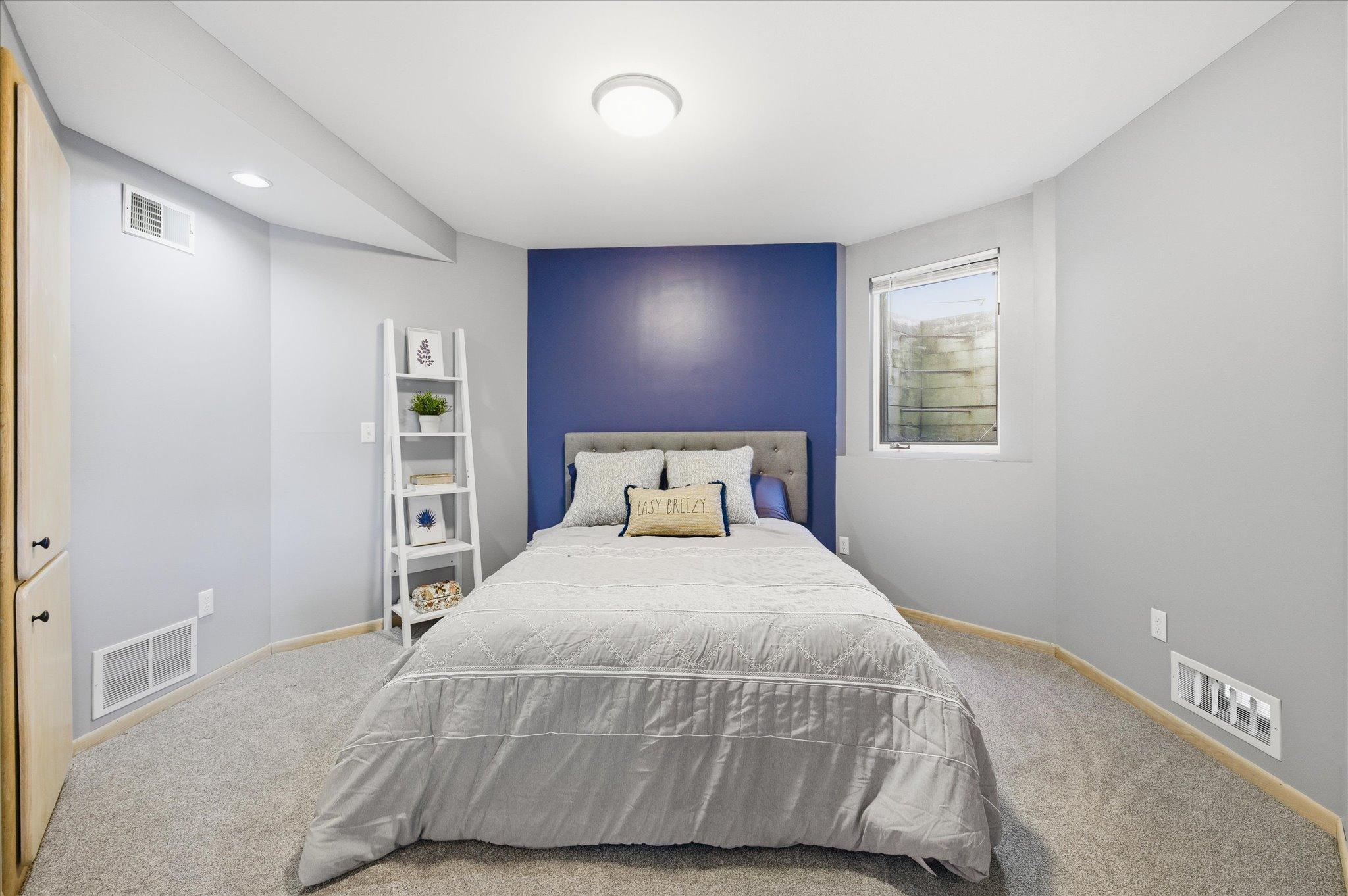 Lower-level bedroom with egress window and generous closet space.