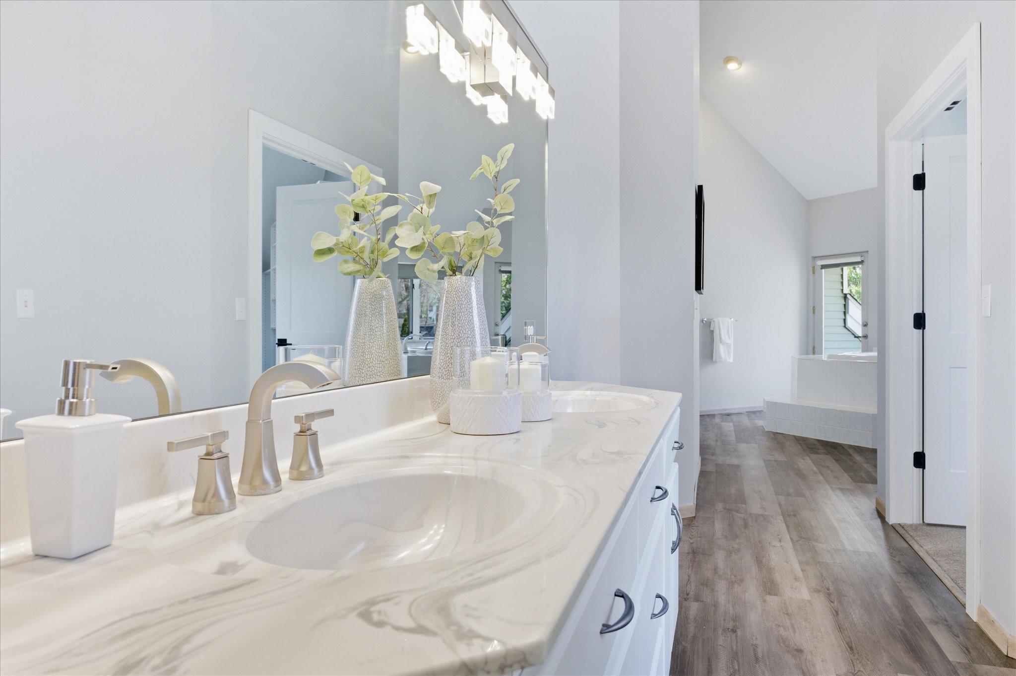 Dual-sink vanity in the primary bathroom with updated countertop and fixtures.