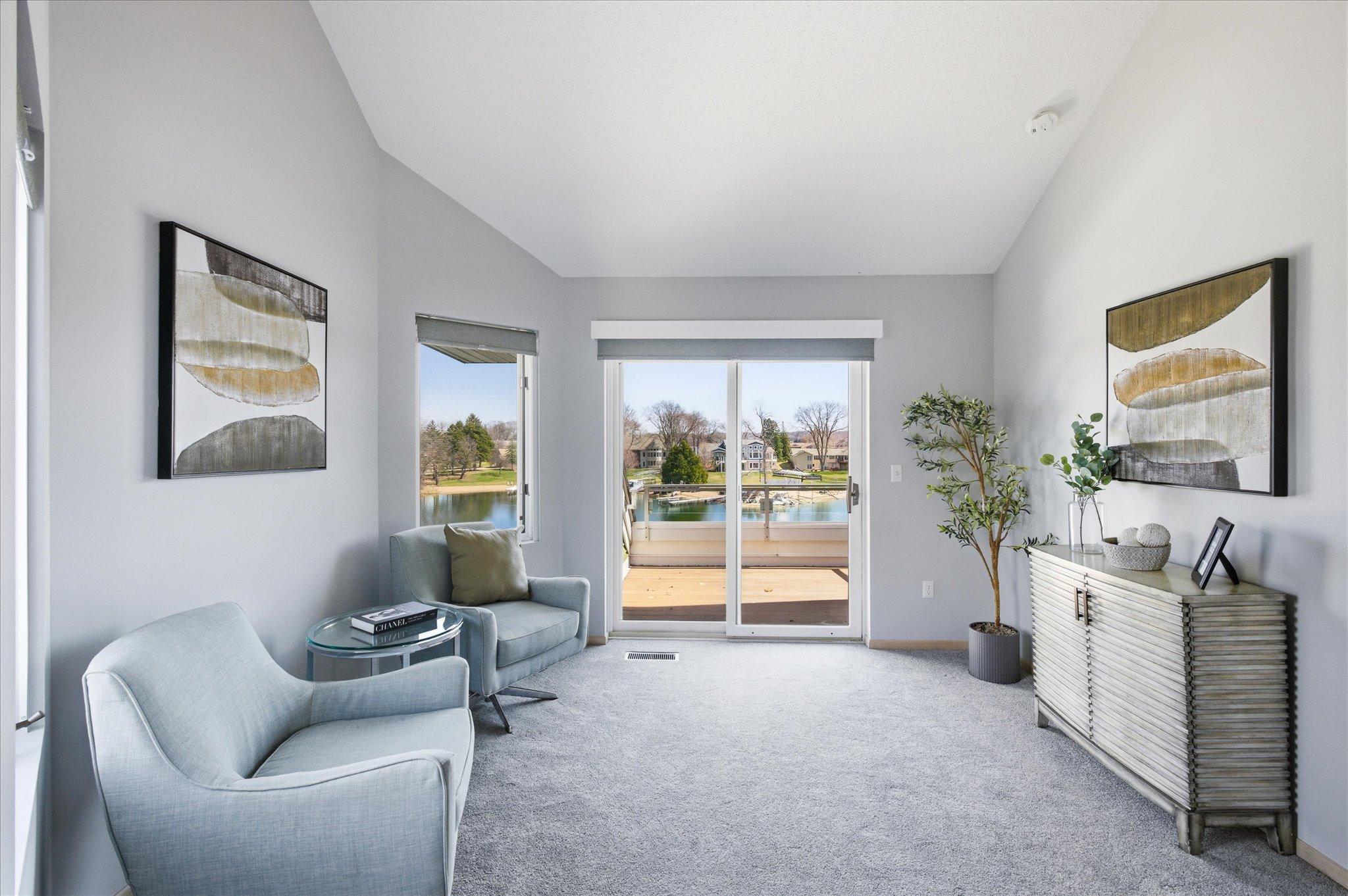 Additional view of the primary suite sitting area and private deck.