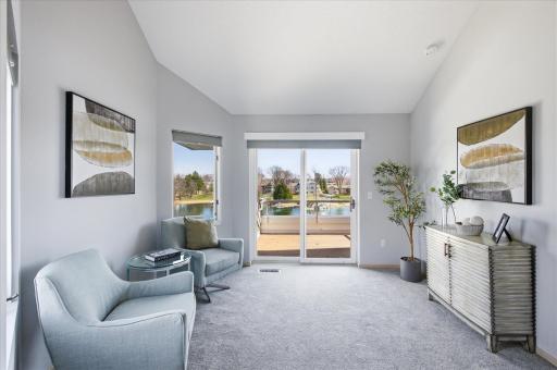 Additional view of the primary suite sitting area and private deck.