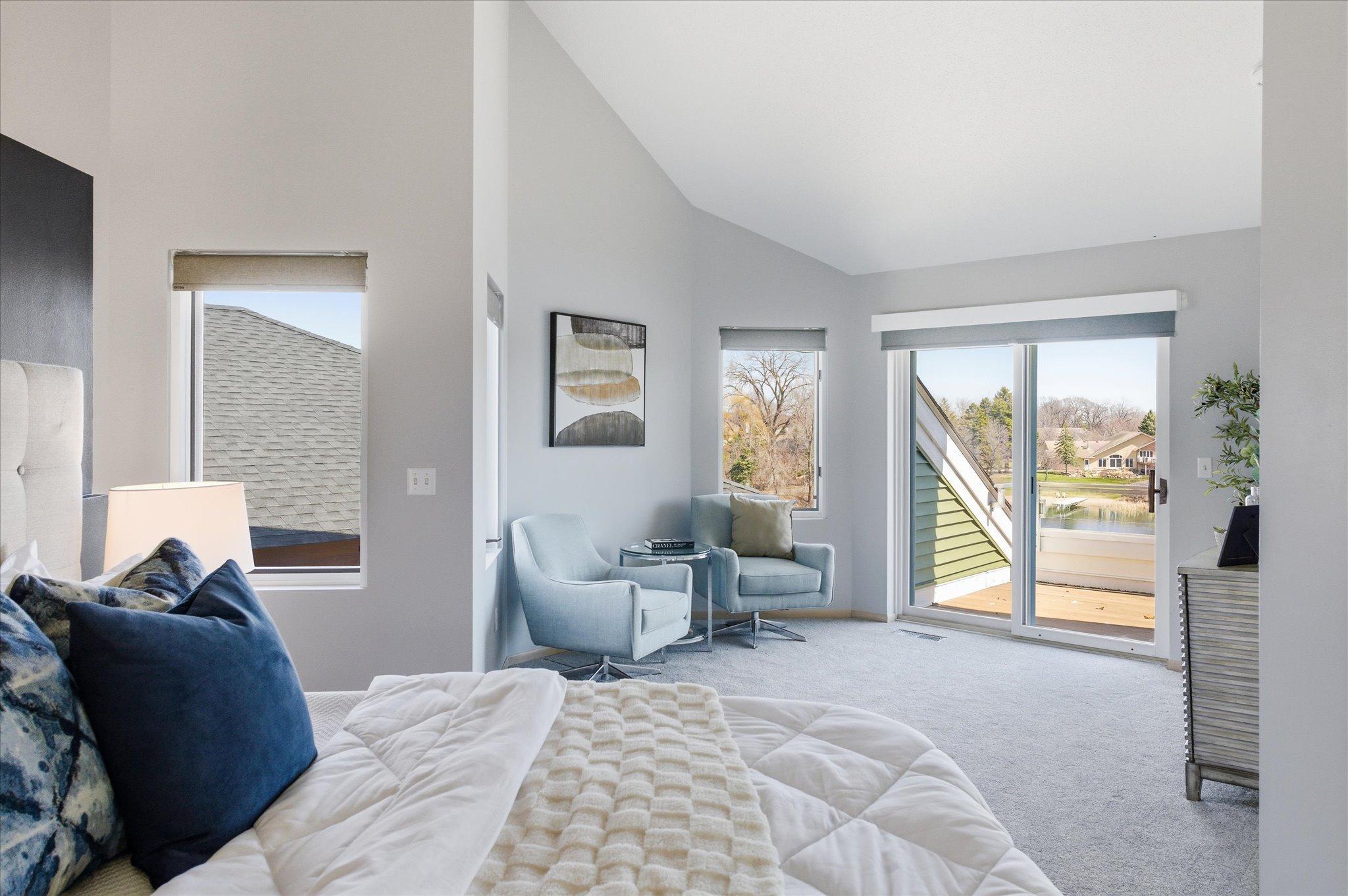 Primary suite sitting area with lake views and private deck access.