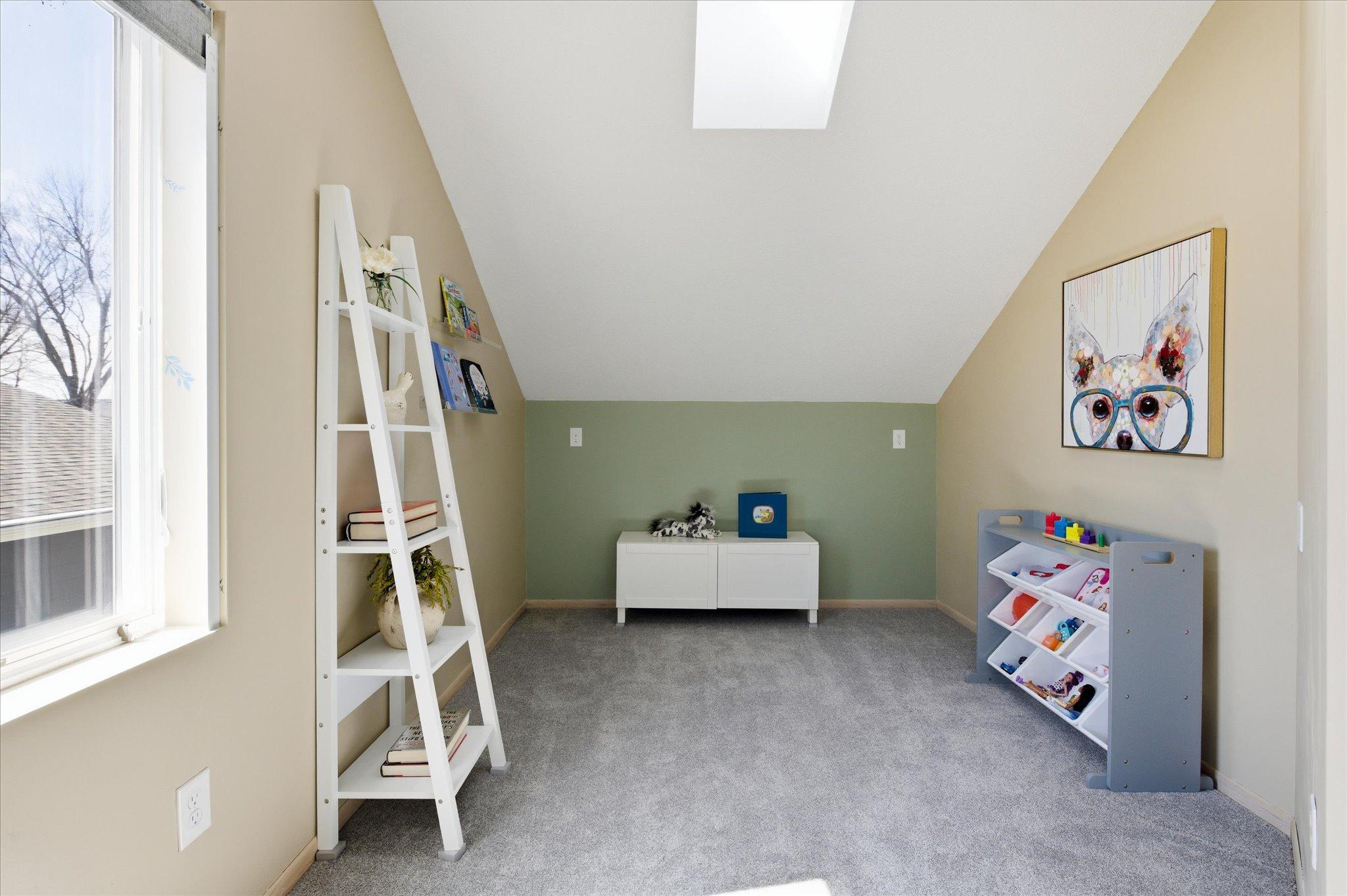Additional upper-level bedroom suitable for a playroom, hobby room, reading nook, or nursery